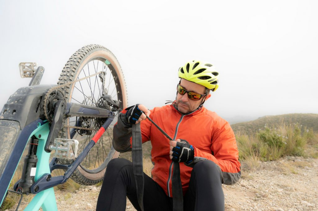 cyclist repairs puncture wheel his bicycle